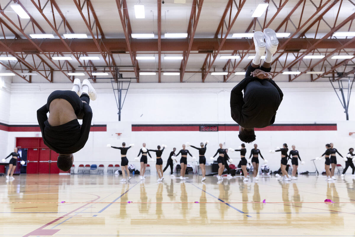 Sophomores Amajhai Reed, left, and Aaron Marentic practice back tucks during the Rebel Girls & ...