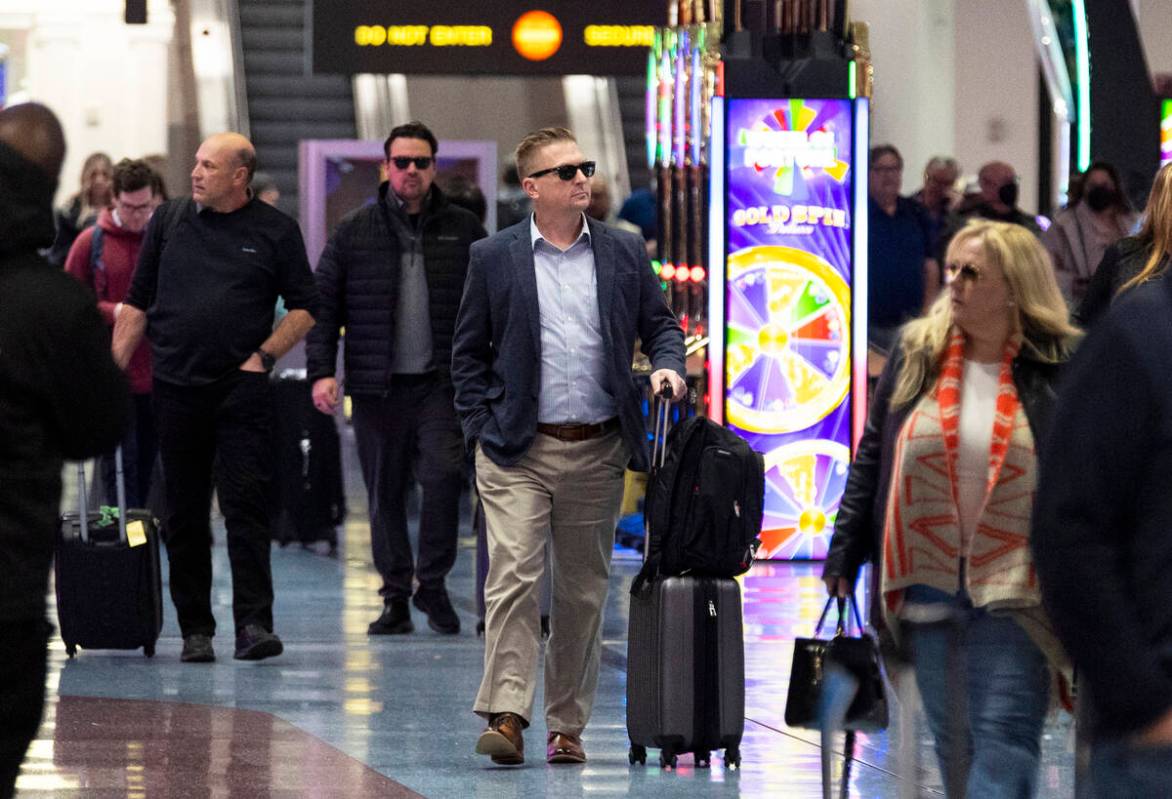 People arrive to the baggage claim area of Terminal 1 at Harry Reid International Airport in La ...