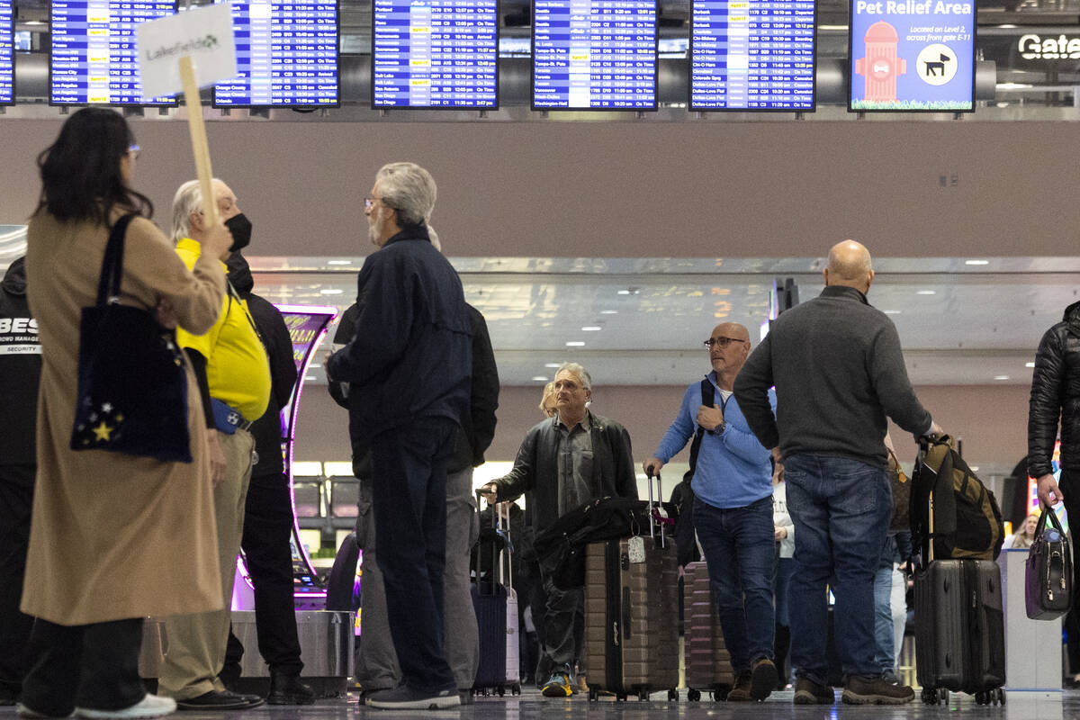 People arrive to the baggage claim area of Terminal 1 at Harry Reid International Airport in La ...