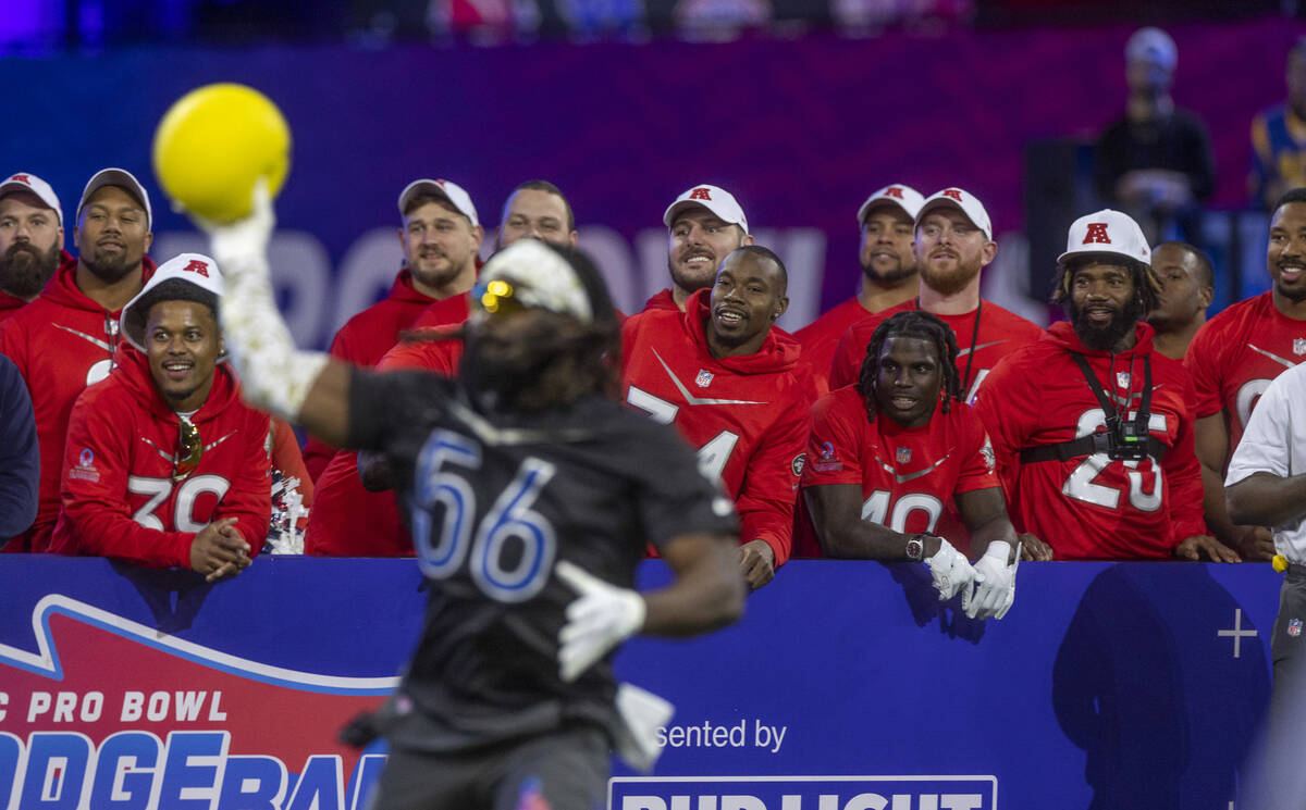 AFC teammates watch the action as the NFC's Demario Davis (56) of the Saints winds up for anoth ...