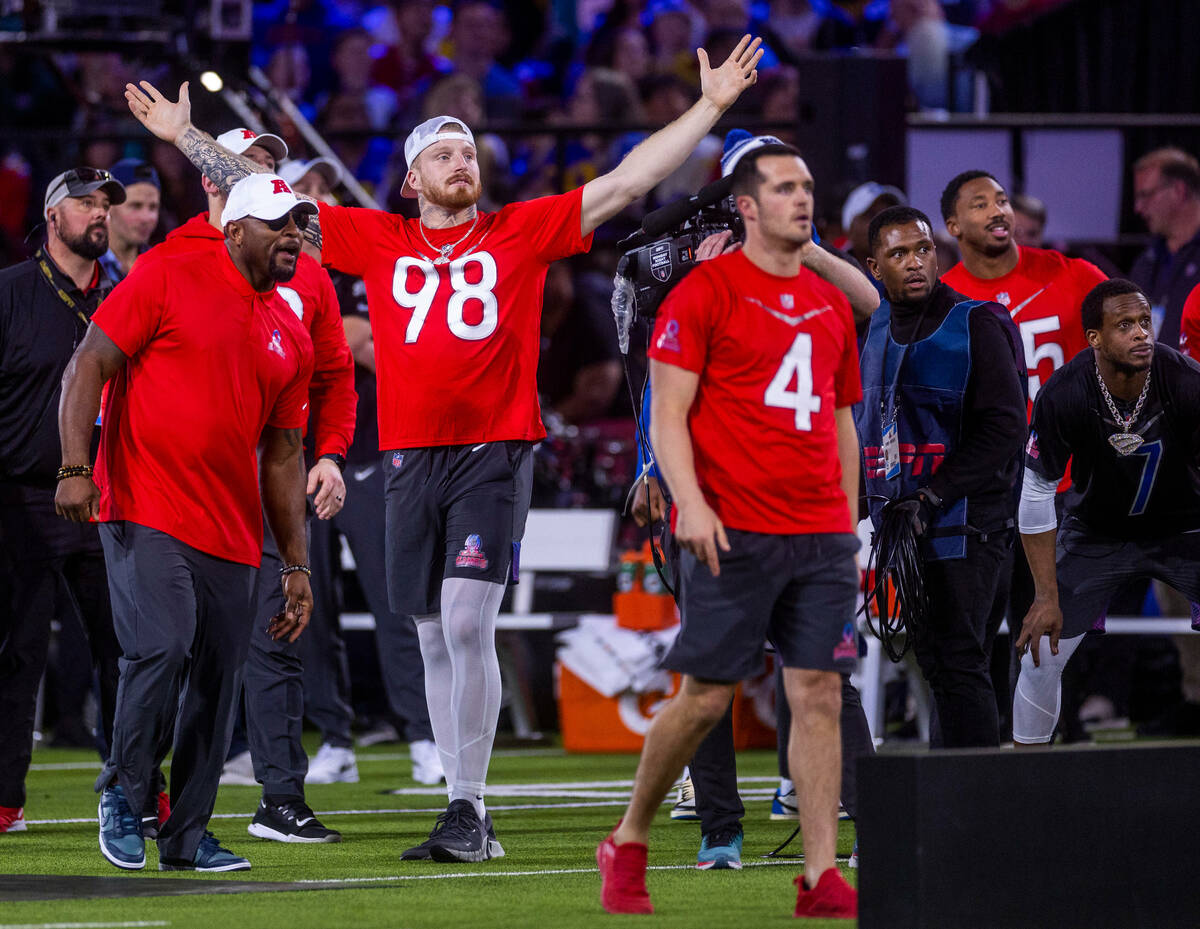 The AFC's Maxx Crosby (98) of the Raiders is pumped as Derek Carr (4, right) with the Raiders ...