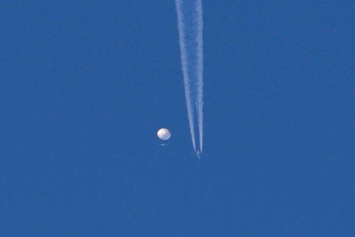 In this photo provided by Brian Branch, a large balloon drifts above the Kingstown, N.C. area, ...