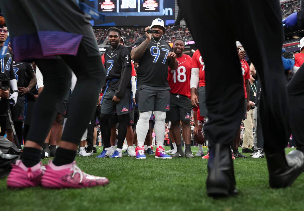 New York Giants defensive tackle Dexter Lawrence (97) records the Blue Man Group during the NFL ...