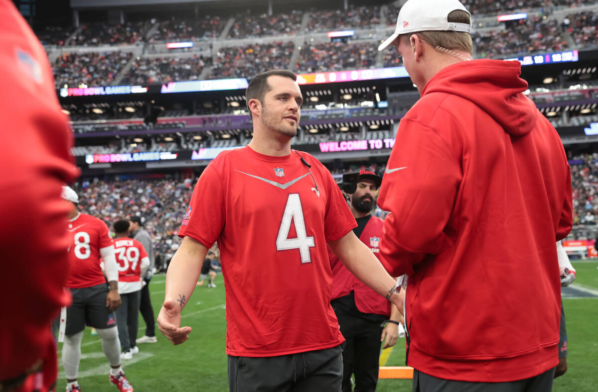 Las Vegas Raiders quarterback Derek Carr (4) talks with AFC head coach Peyton Manning during th ...