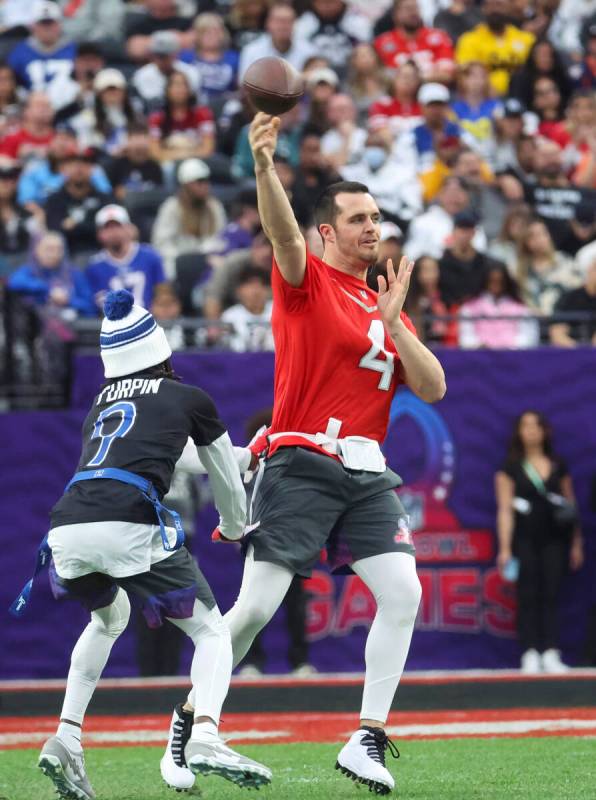 Las Vegas Raiders quarterback Derek Carr (4) looks to throw a pass under pressure from Dallas C ...