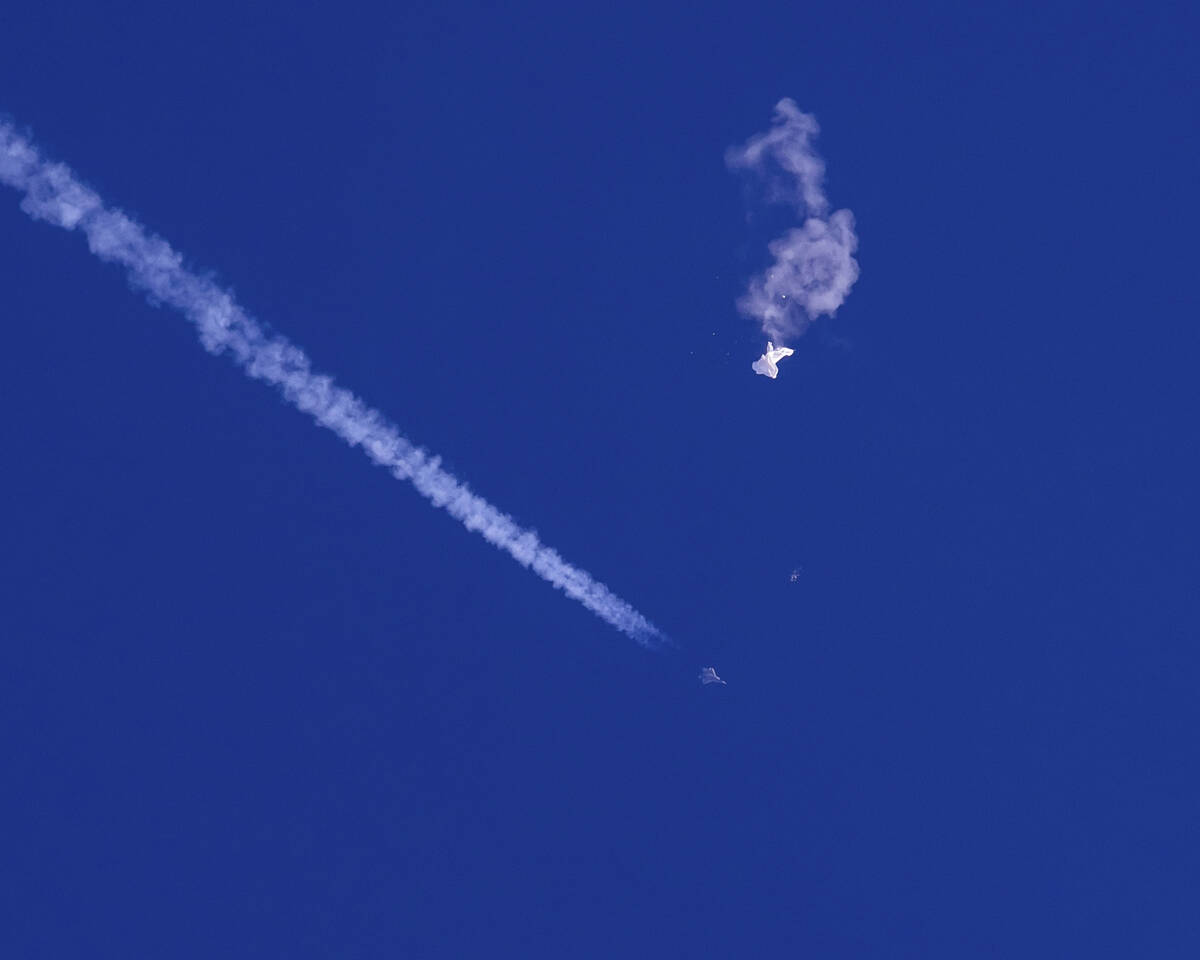 In this photo provided by Chad Fish, the remnants of a large balloon drift above the Atlantic O ...