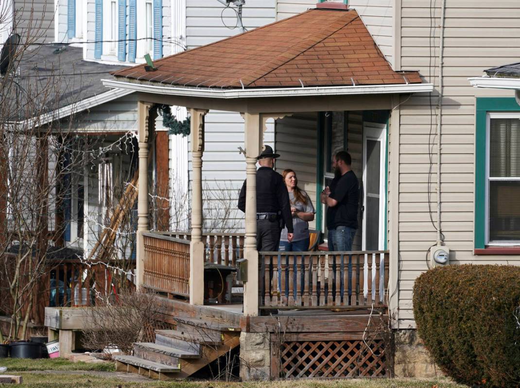 An Ohio state trooper goes door to door telling residents to leave downtown East Palestine, Ohi ...