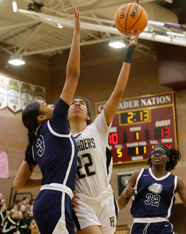 Faith Lutheran's Ariel Thomas (22) tires to shoots over Centennial's Charlece Ohiaeri (3) as Ce ...