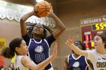 Centennial's Kaniya Boyd (00) shoots the ball as Faith Lutheran's Leah Mitchell (34) and Faith ...