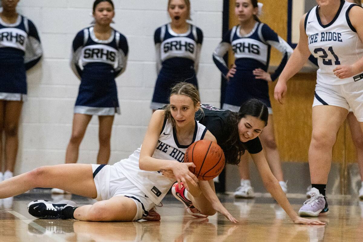 Shadow Ridge's Kelly Megown (4) and Faith Lutheran's Emma Herpin (33) fight for the loose ball ...