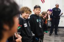 Clark County School District Police Officer Artesia Henry laughs with kids as she leads a class ...