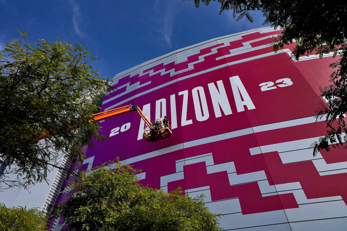 Workers prepare State Farm Stadium, Friday, Feb. 3, 2023, in Glendale, Ariz. for the NFL Super ...