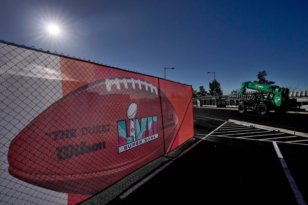 Workers prepare for the NFL Super Bowl LVII football game outside State Farm Stadium, Wednesday ...