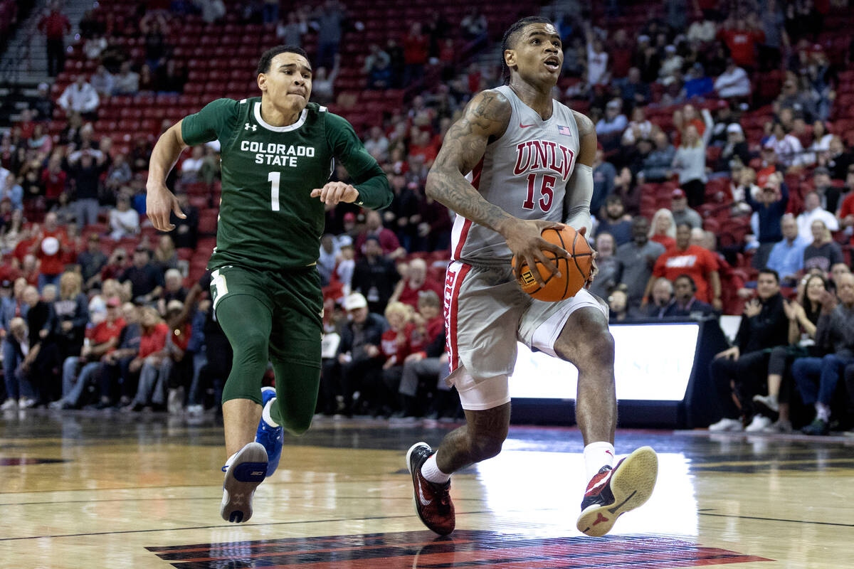 UNLV Rebels guard Luis Rodriguez (15) drives toward the hoop followed by Colorado State Rams gu ...