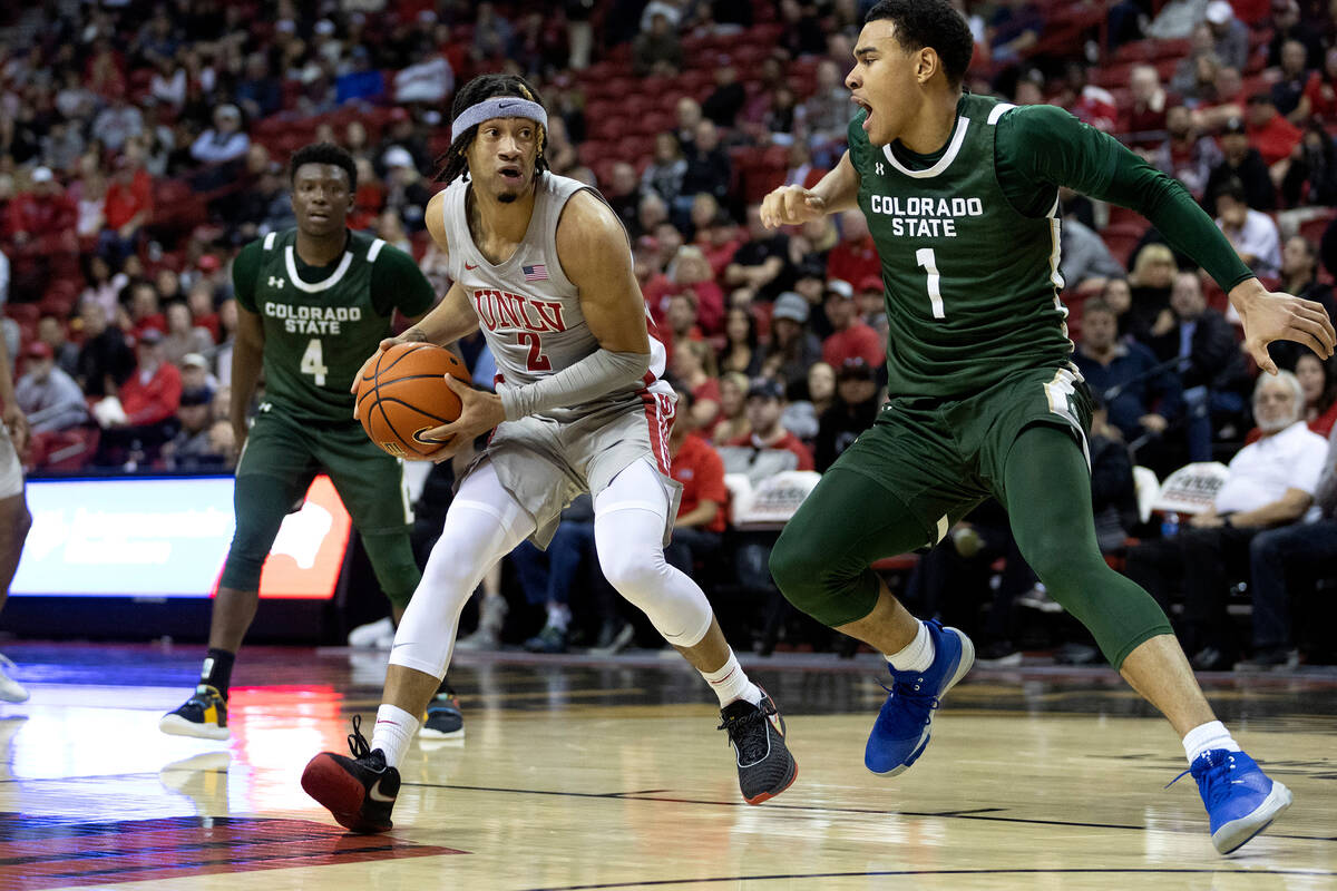 UNLV Rebels guard Justin Webster (2) drives toward the hoop around Colorado State Rams guard Jo ...