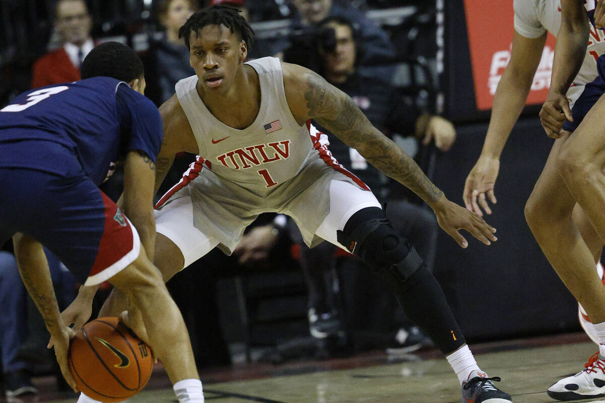 UNLV Rebels guard Elijah Parquet (1) tries to stop Fresno State Bulldogs guard Isaiah Hill (3) ...