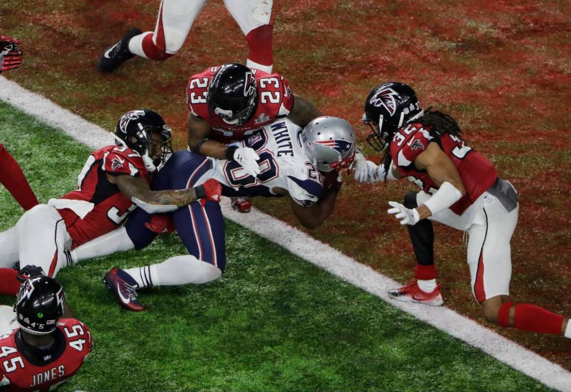 In this Feb. 5, 2017, file photo, New England Patriots' James White scores the winning touchdow ...