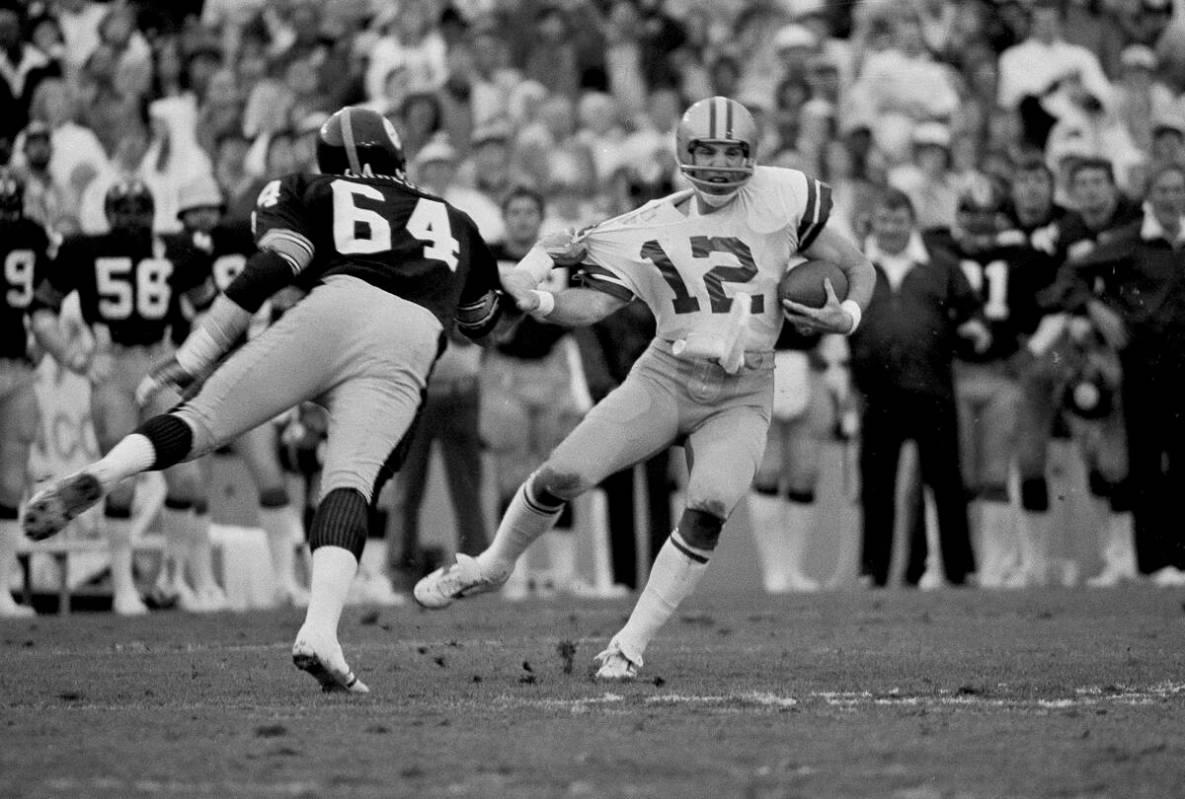 Dallas Cowboys quarterback Roger Staubach is caught by Pittsburgh Steelers Steve Furness during ...