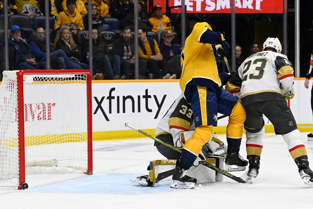 A Nashville Predators shot hits the goal post as Predators center Yakov Trenin, second from lef ...