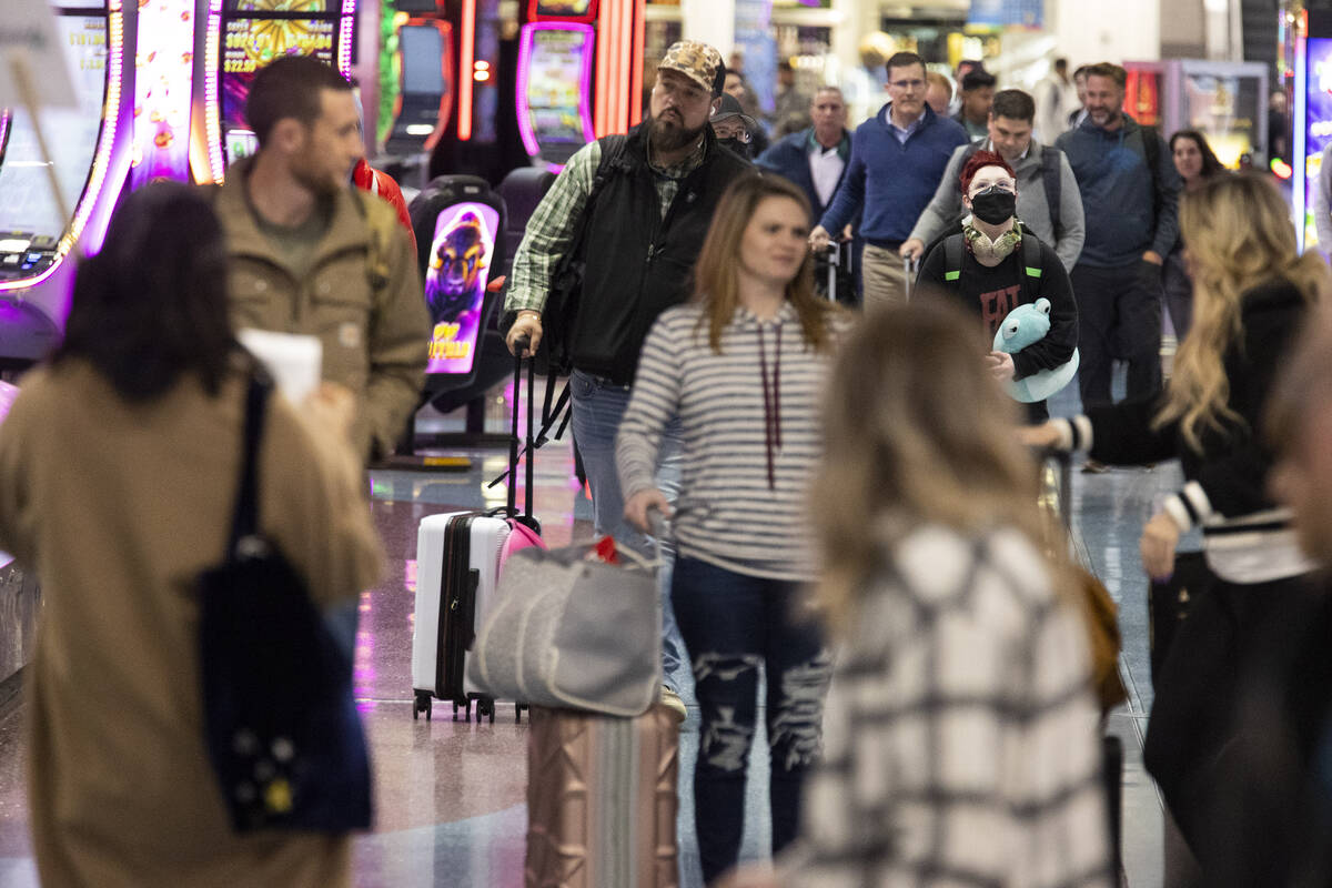 People arrive to the baggage claim area of Terminal 1 at Harry Reid International Airport in La ...