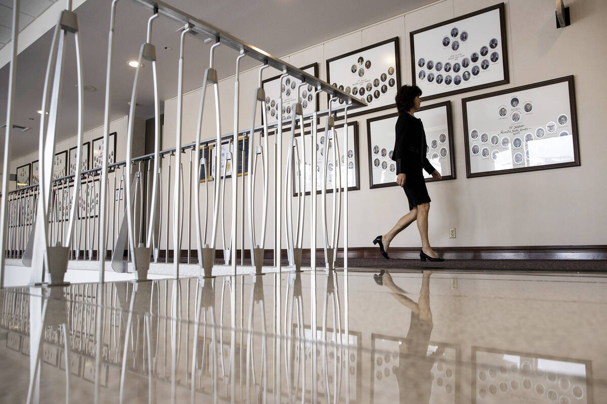 Sen. Heidi Seevers Gansert, R-Reno, walks past portraits of past Nevada Senate sessions during ...