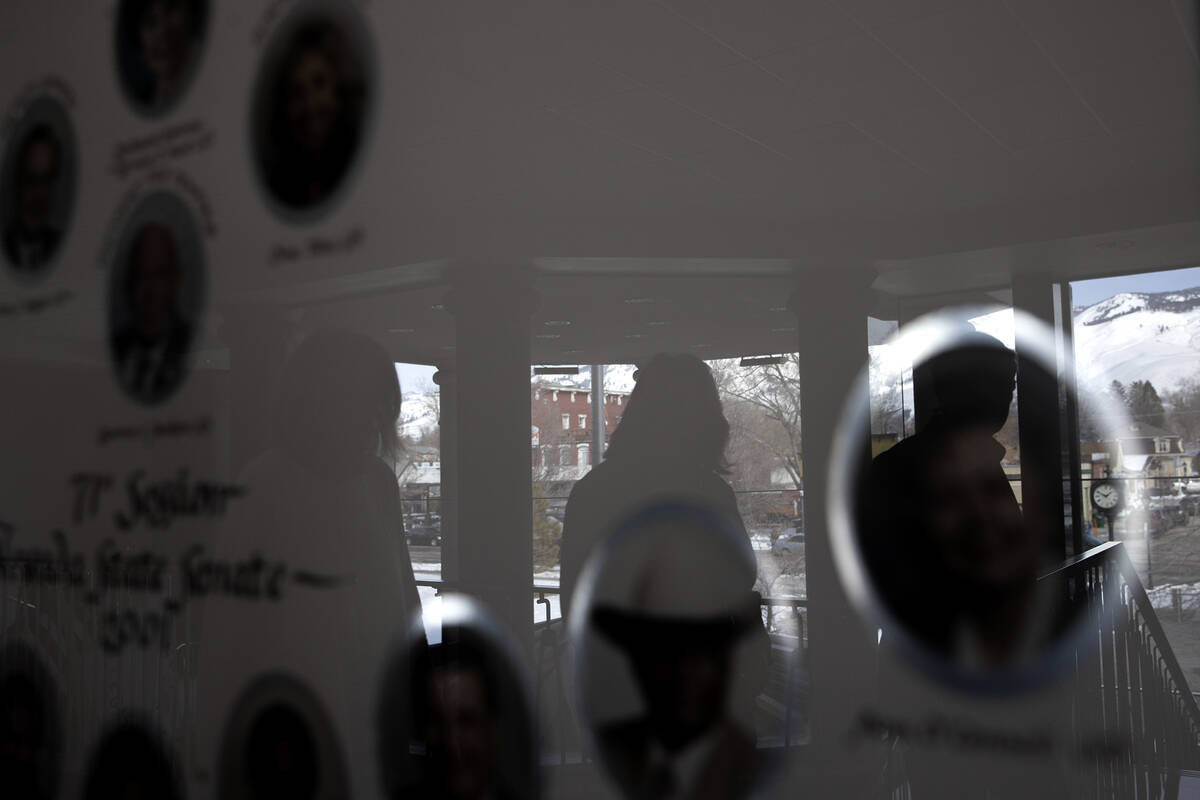 Downtown Carson City and passersby are reflected in a portrait of the 2001 71st Session of the ...