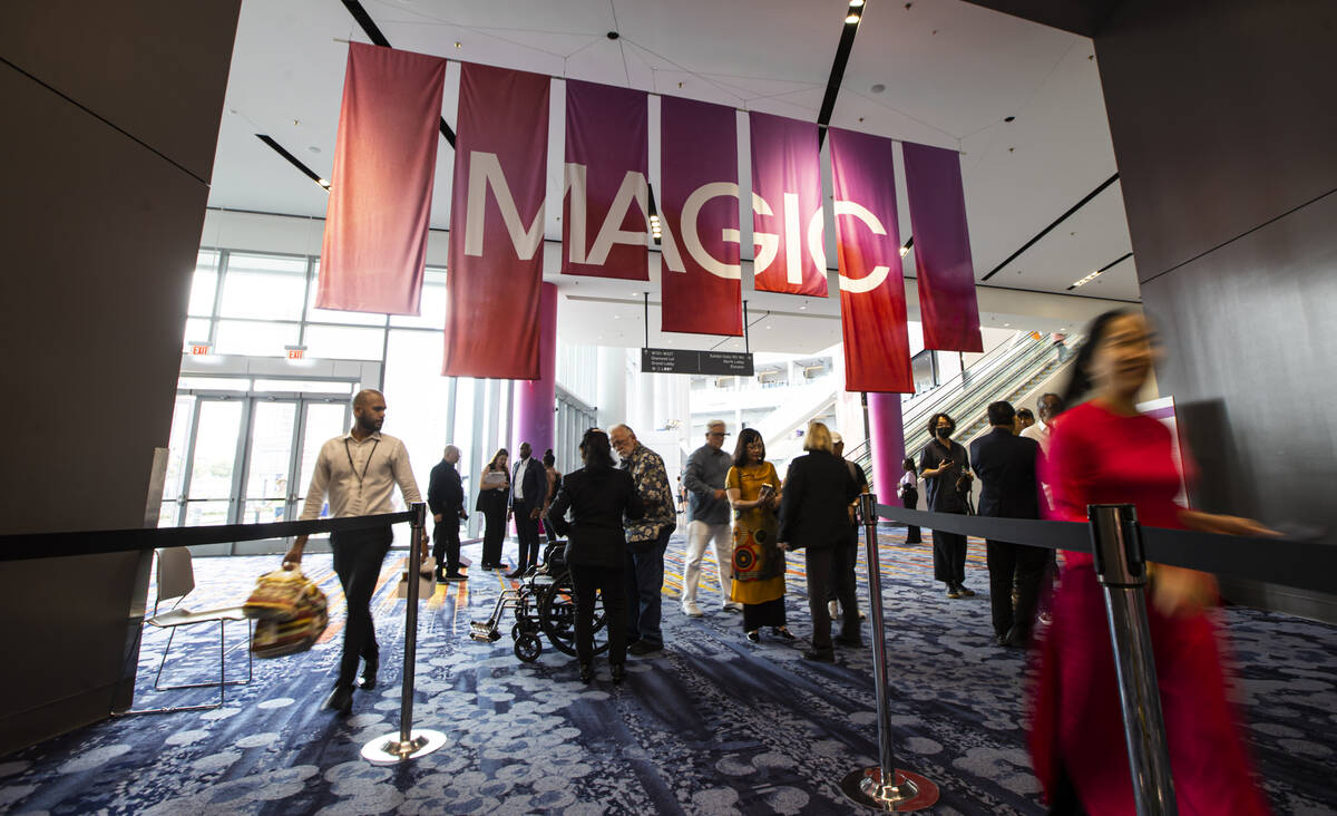 Visitors walk into an exhibit hall during the MAGIC Las Vegas fashion trade show on Monday, Aug ...