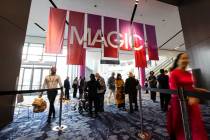 Visitors walk into an exhibit hall during the MAGIC Las Vegas fashion trade show on Monday, Aug ...
