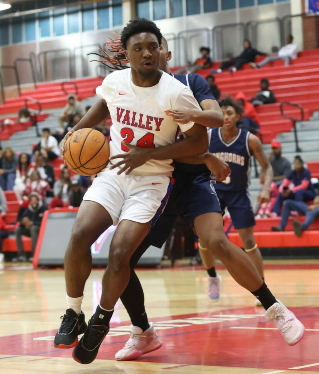 Valley's Tahje Hutchinson (24) moves the ball around Legacy defense during the first half a bas ...