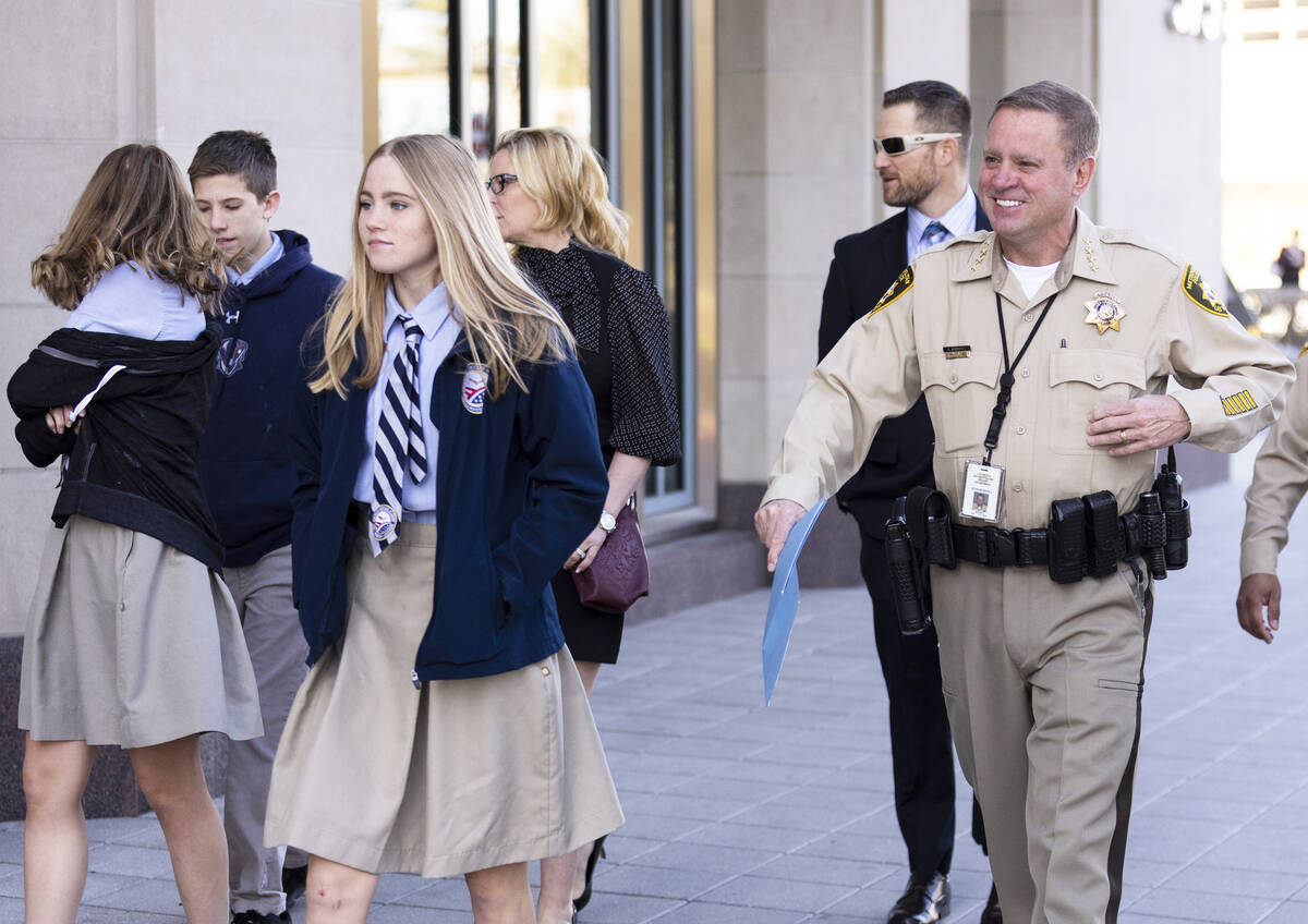 Sheriff Kevin McMahill, right, arrives to the Myron's at The Smith Center in Las Vegas, with hi ...