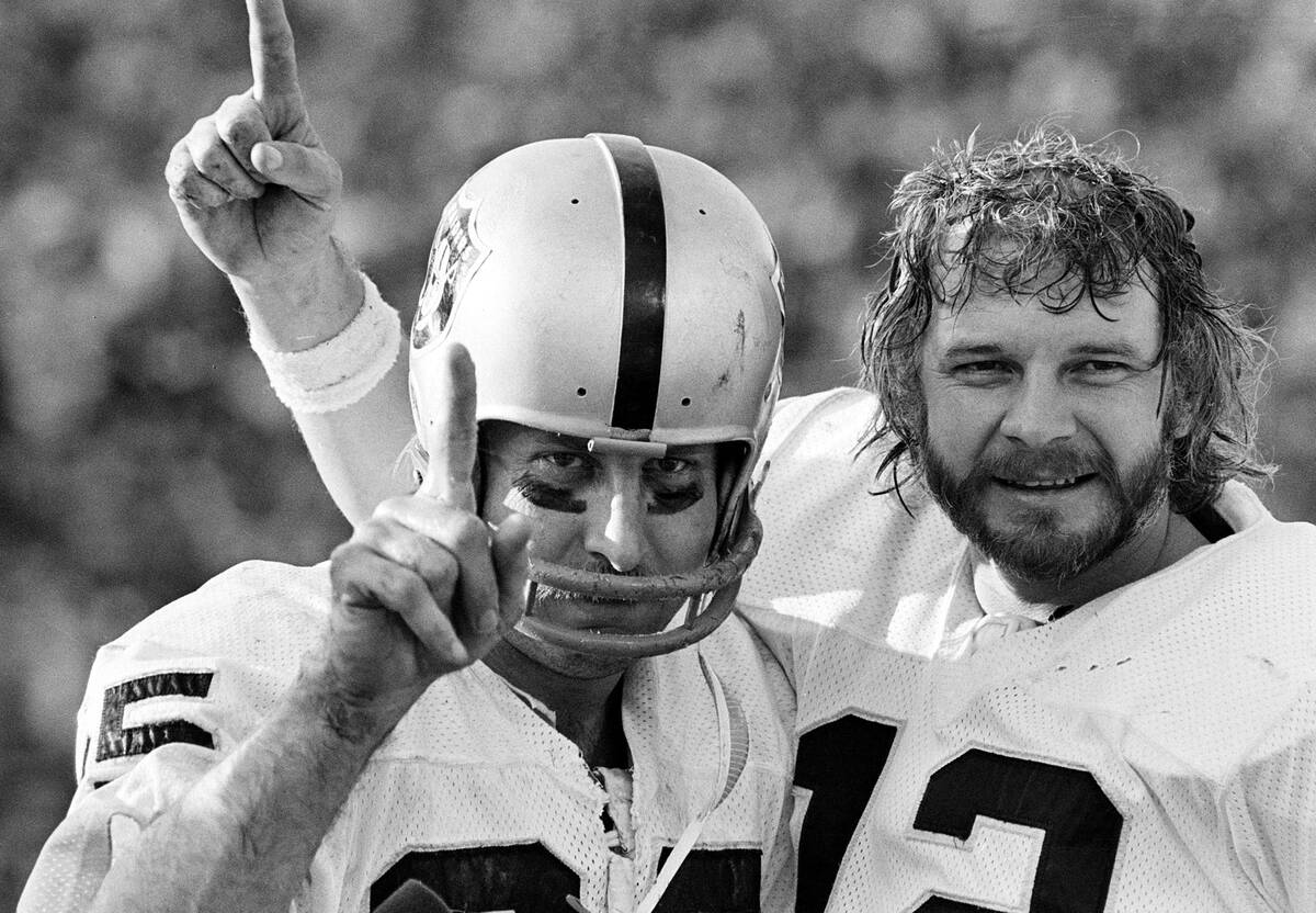 FILE - Oakland Raiders receiver Fred Biletnikoff, left, and quarterback Ken Stabler gesture aft ...