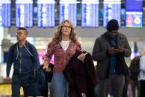 Travelers walk through terminal 1 at Harry Reid International Airport on Sunday, Nov. 27, 2022, ...