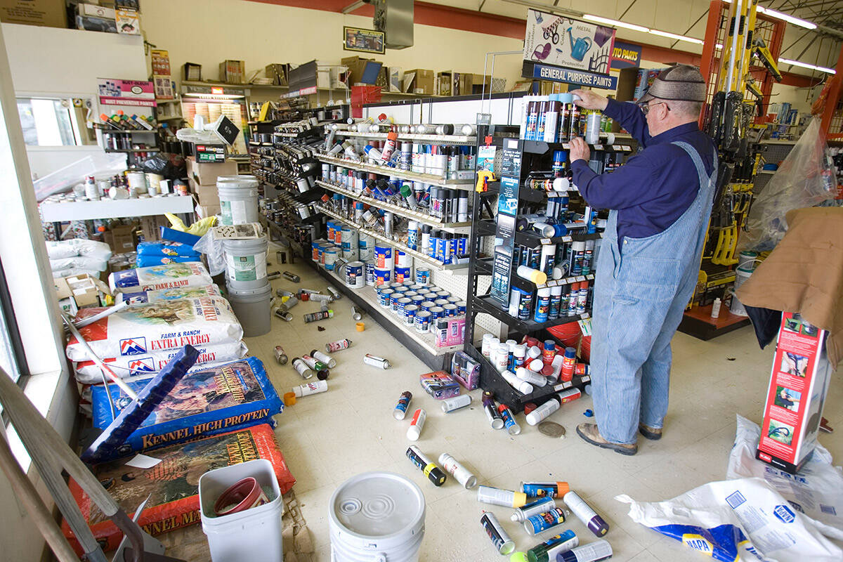 An unidentified man restocks the shelves of an hardware store in Wells in February 2008 after a ...