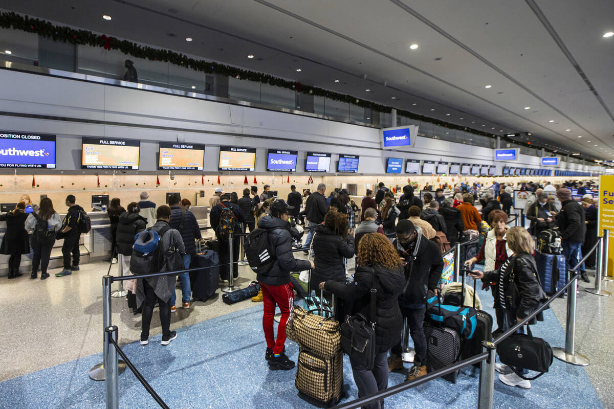 Passengers line up to check in at Southwest Airlines at Harry Reid International Airport on Thu ...