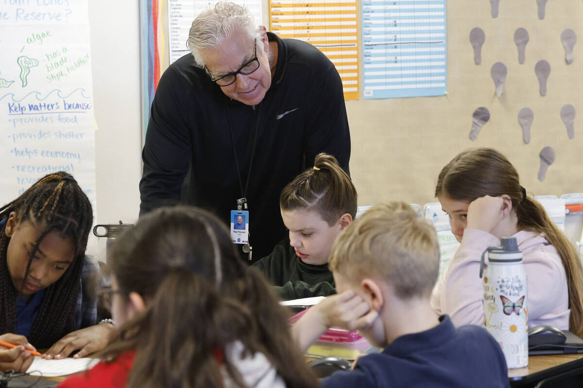 Ray Finucan, special education teaching assistant, helps children during a fifth grade class at ...