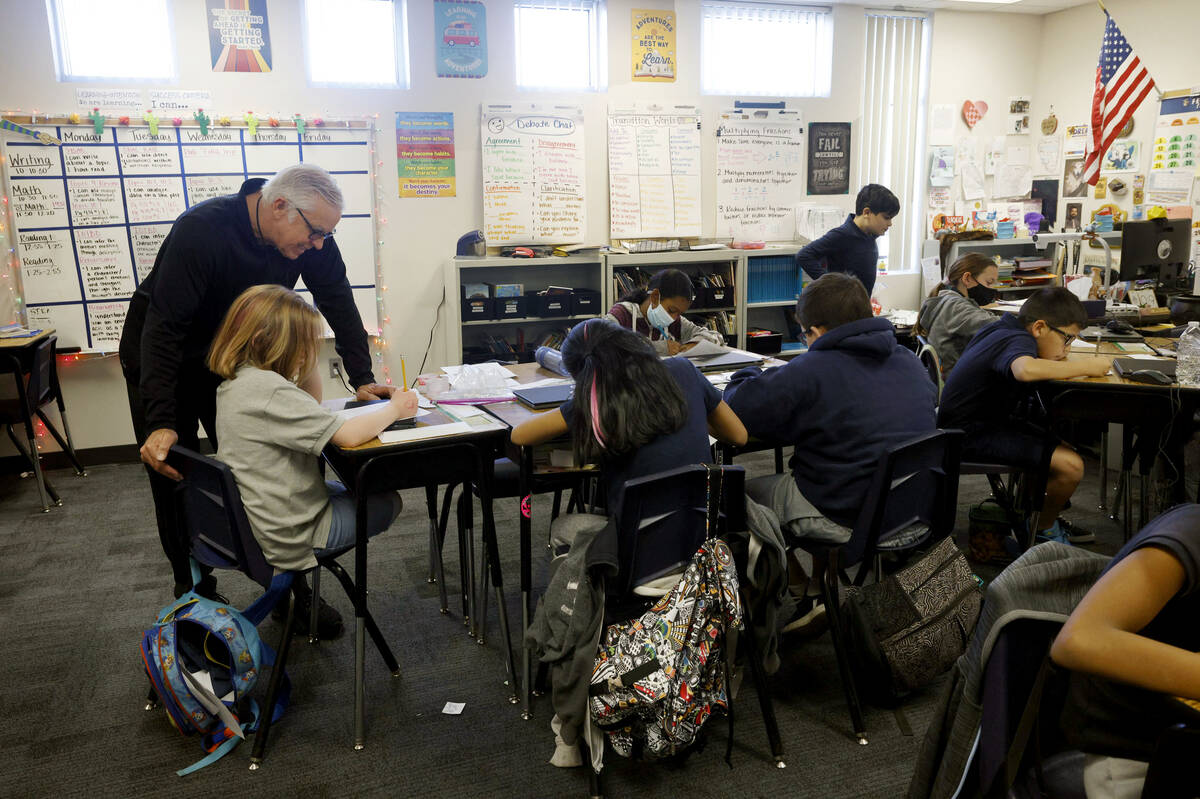 Ray Finucan, special education teaching assistant, helps children during a fifth grade class at ...