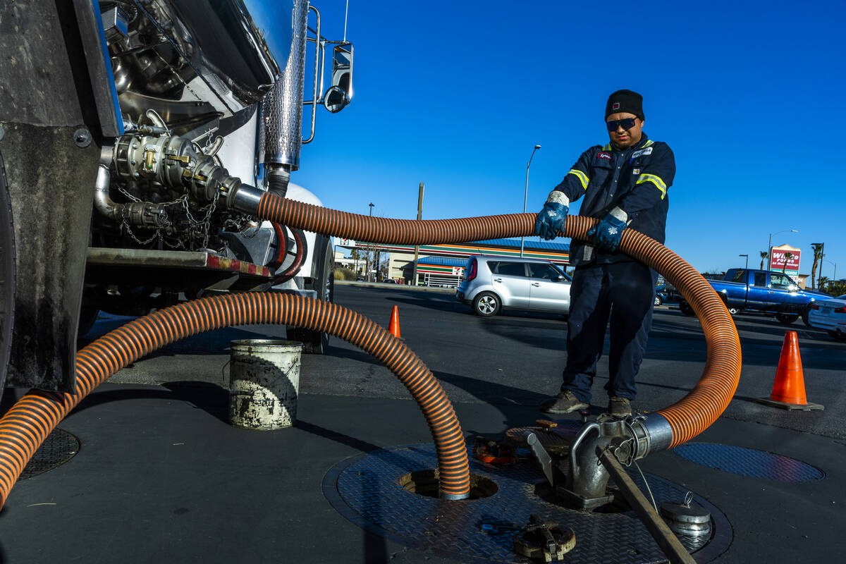 Ignacio Lopez with the Rebel Oil Company fuels up tanks at the Rebel gas station on North Buffa ...