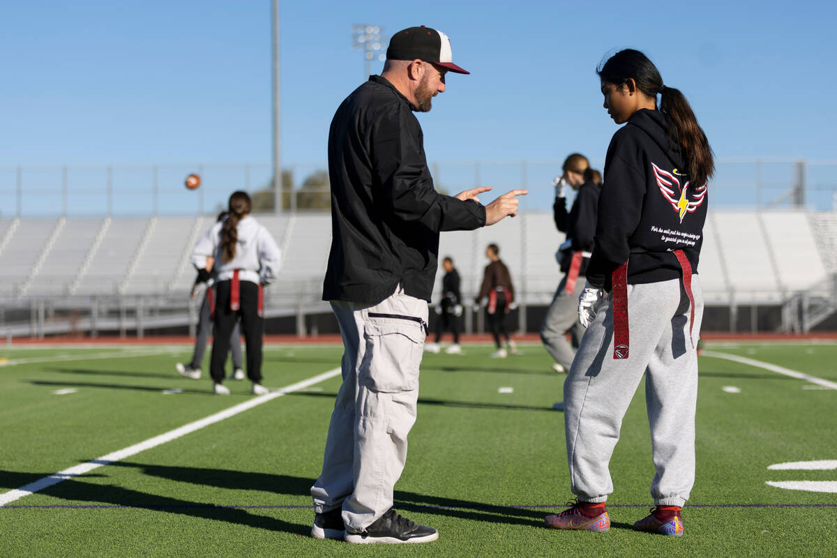 Allie Peralta, right makes a catch during a flag football practice at Desert Oasis High School ...