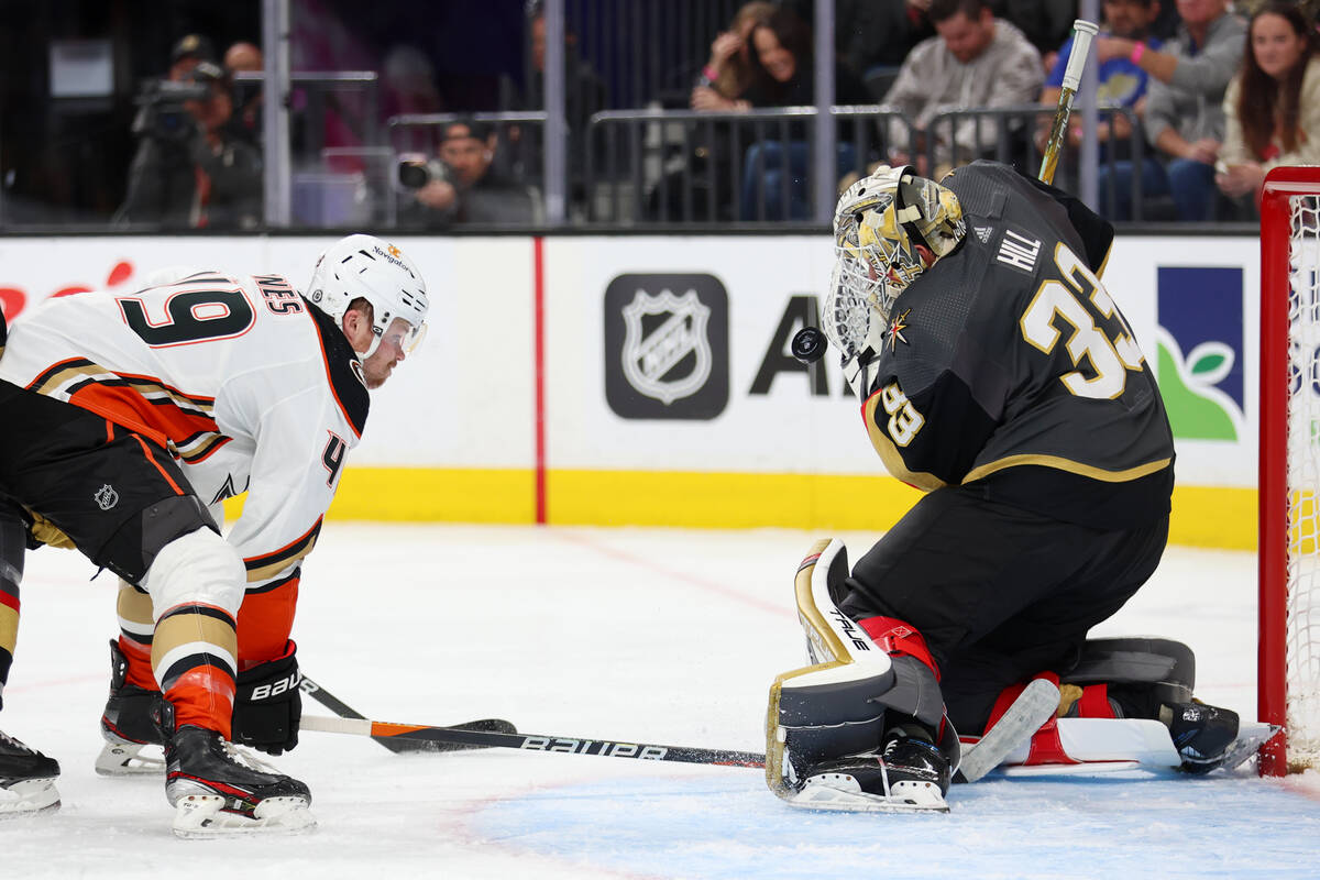 Vegas Golden Knights goaltender Adin Hill (33) defends against Anaheim Ducks left wing Max Jone ...