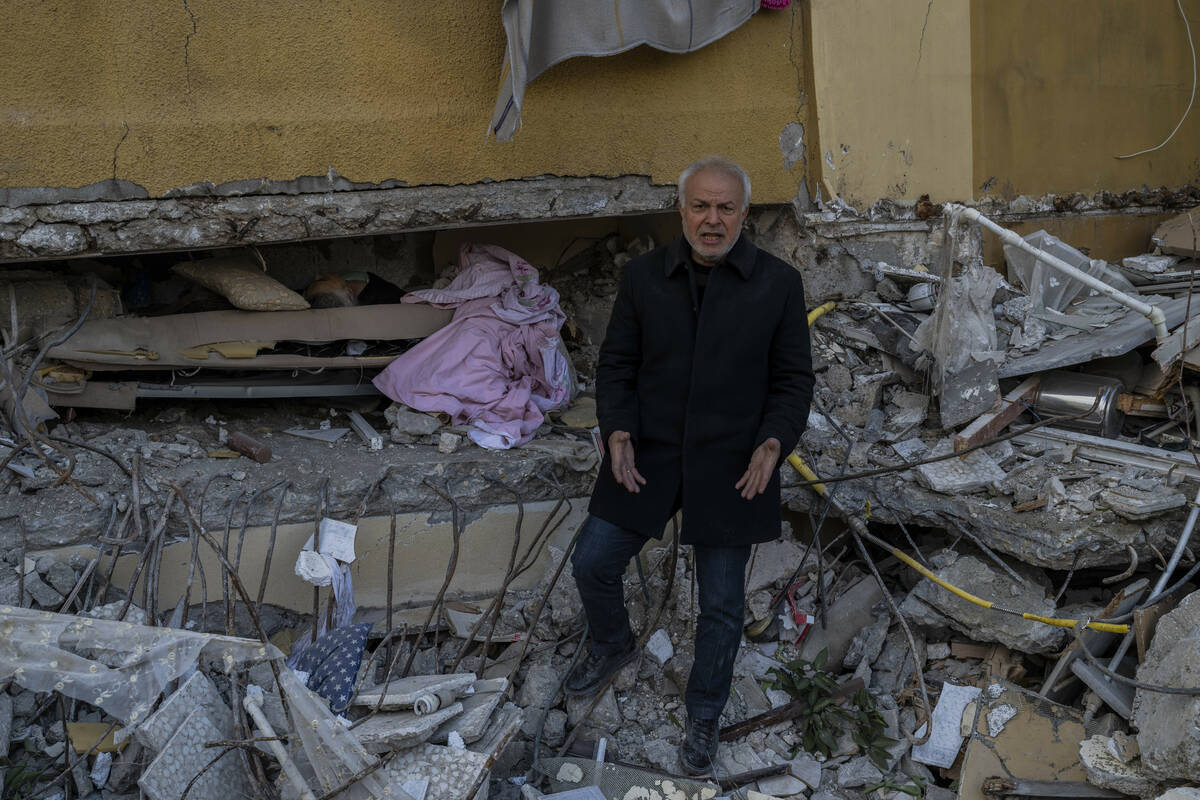 A man screams angrily next to the body of his dead mother in Antakya, southeastern Turkey, Satu ...