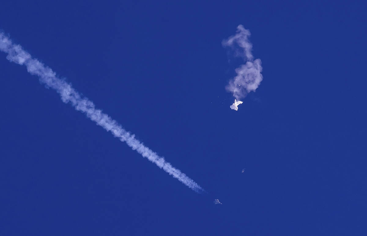 In this photo provided by Chad Fish, the remnants of a large balloon drift above the Atlantic O ...