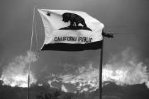 The California state flag flies next to a home on Highway 94 south Potrero, Calif., on Monday, ...