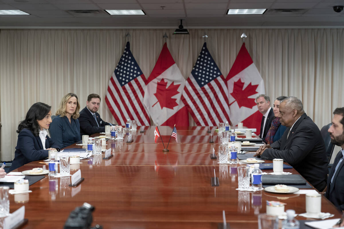 Secretary of Defense Lloyd Austin, right, meets with Canada's Minister of National Defense Anit ...