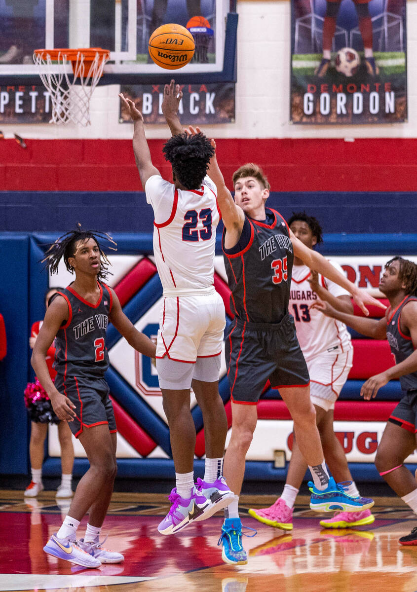 Coronado's Josiah Cunningham (23) gets a shot off over Arbor View's Wyatt Jaeck (35) during the ...