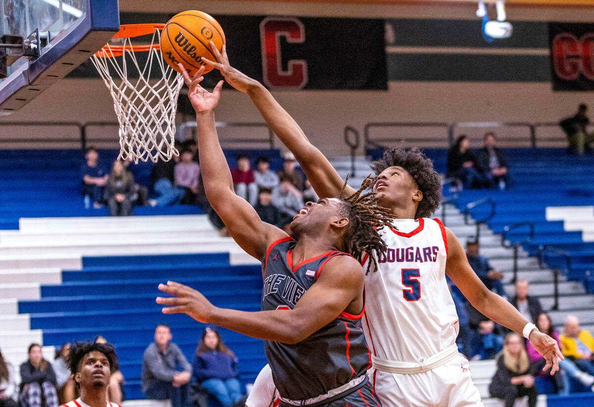 Arbor View's Brian Townsend (3) has a lay up rejected by Coronado's Lantz Stephenson (5) during ...