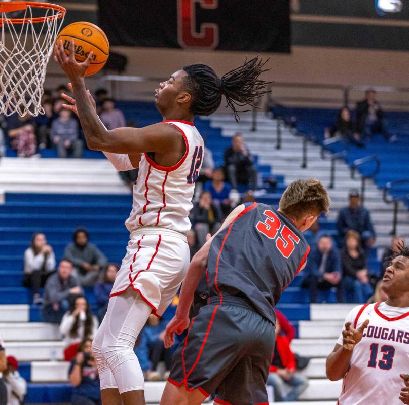 Coronado's Sebastian Mack (12) gets to the rim after colliding with Arbor View's Wyatt Jaeck (3 ...