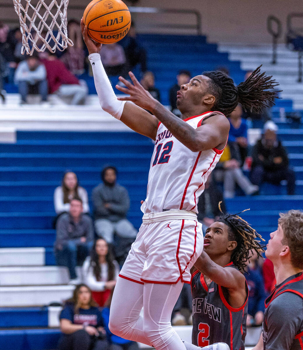 Coronado's Sebastian Mack (12) gets to the rim before Arbor View's Sebastian Knox (2) arrives d ...