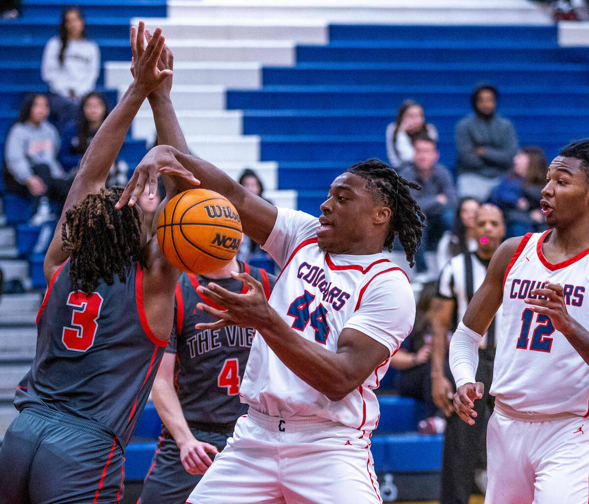 Coronado's Ifiok Peter (44) grabs a rebound away from Arbor View's Brian Townsend (3) during th ...