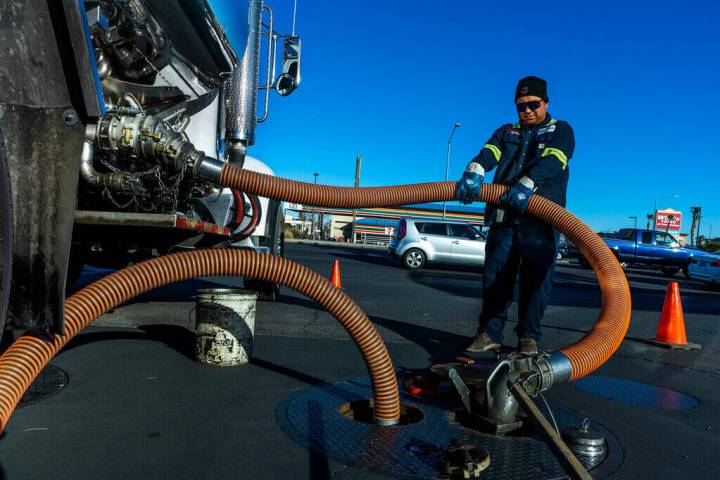 Ignacio Lopez with the Rebel Oil Company fuels up tanks at the Rebel gas station on North Buffa ...