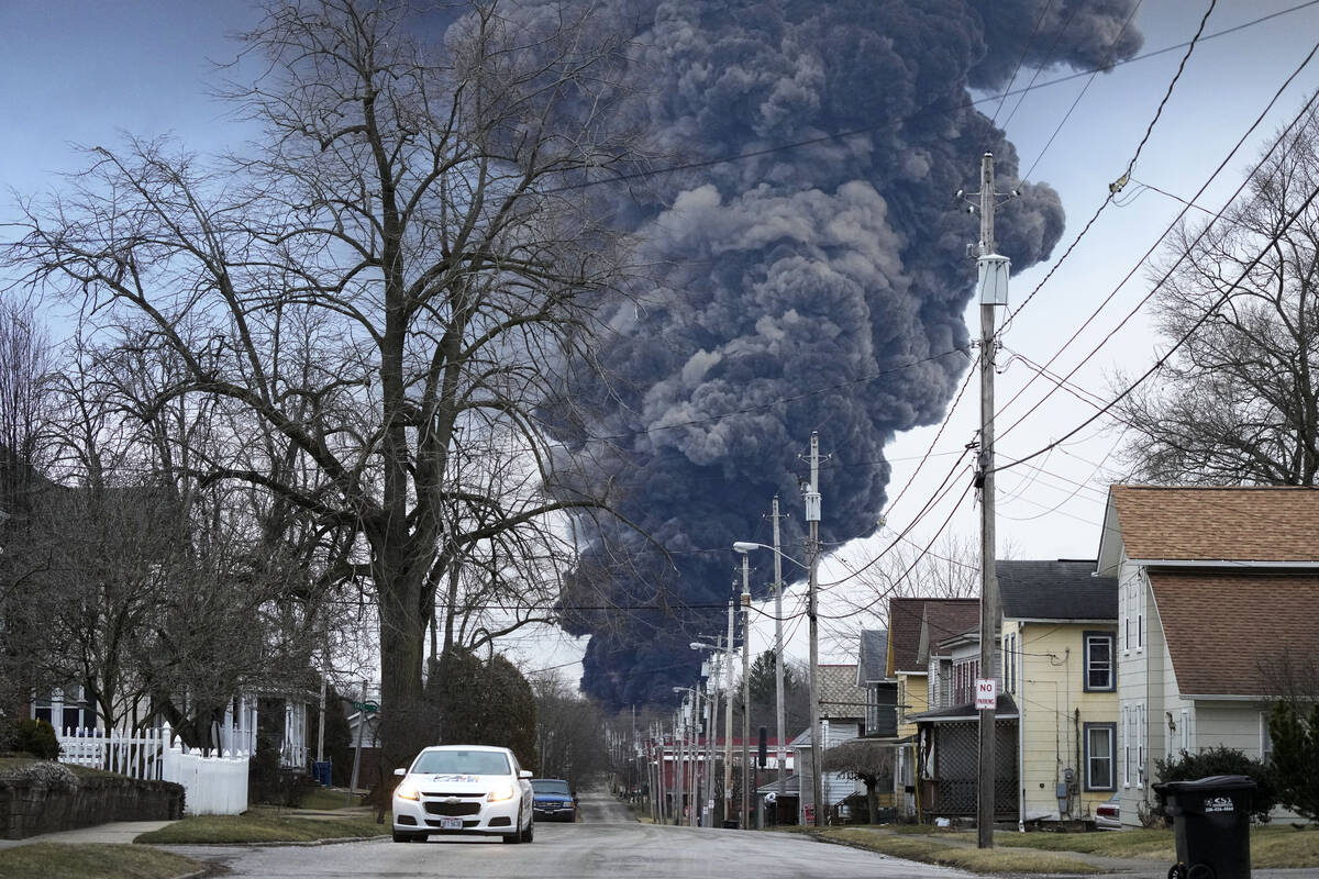 A black plume rises over East Palestine, Ohio, as a result of a controlled detonation of a port ...